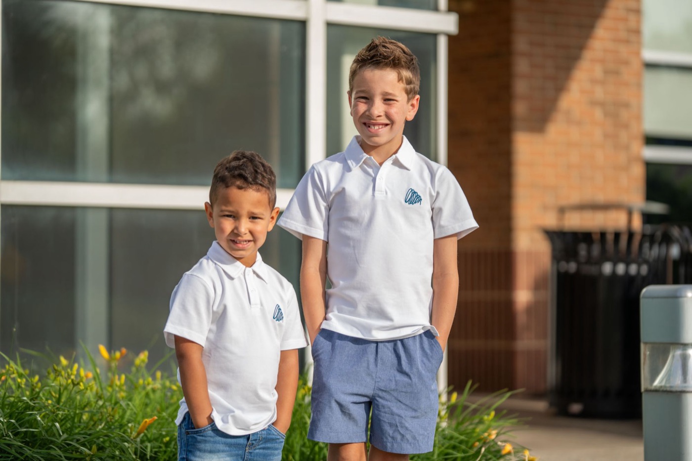 Two boys in white Cam & Coop polo shirts